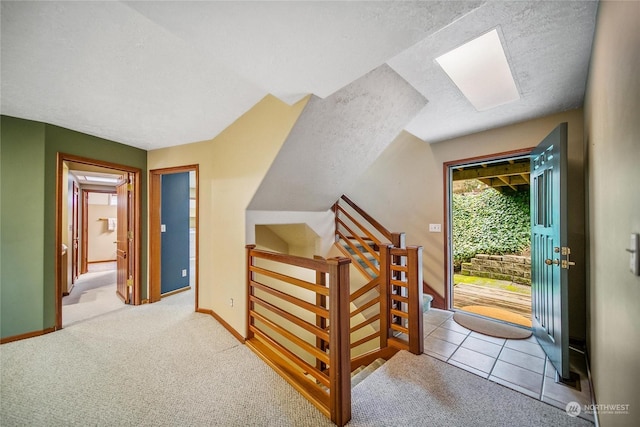 interior space featuring light colored carpet and a textured ceiling