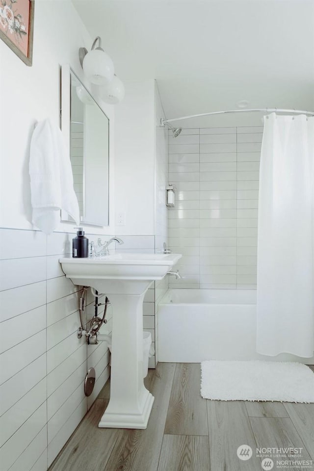 bathroom featuring hardwood / wood-style flooring and shower / tub combo with curtain