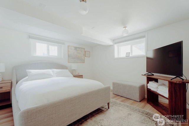 bedroom featuring multiple windows and light hardwood / wood-style floors