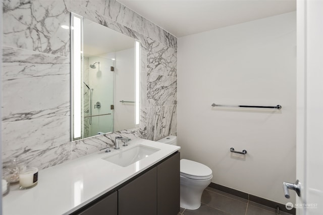 bathroom featuring an enclosed shower, vanity, tile walls, tile patterned flooring, and toilet