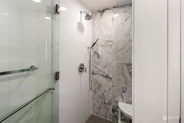 bathroom with a shower with shower door