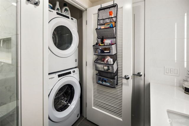 clothes washing area with stacked washer / dryer