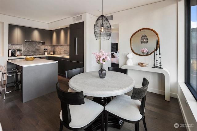 dining space with sink and dark wood-type flooring