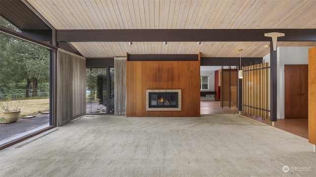 unfurnished living room featuring a fireplace, carpet flooring, and beamed ceiling