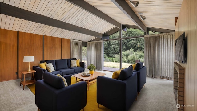 living room with light carpet, vaulted ceiling with beams, floor to ceiling windows, and wood walls