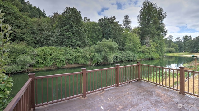 wooden terrace featuring a water view