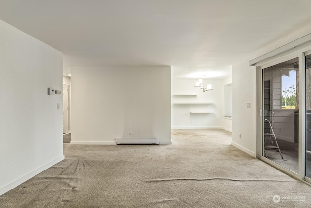 carpeted spare room featuring a baseboard heating unit and a notable chandelier