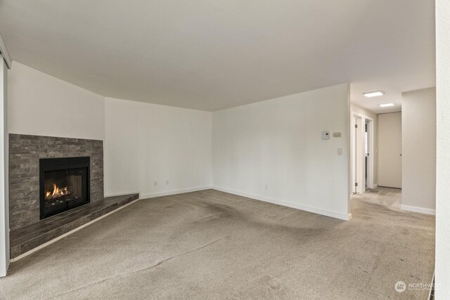 unfurnished living room with light colored carpet