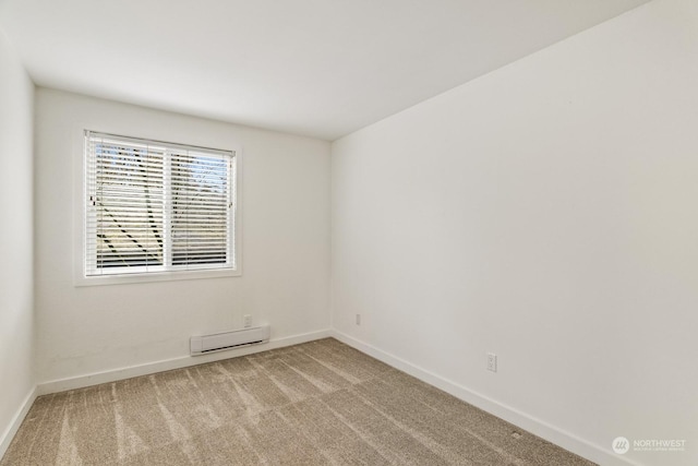 unfurnished room with a baseboard radiator and light colored carpet