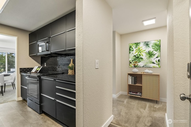 kitchen with light colored carpet, backsplash, and electric stove