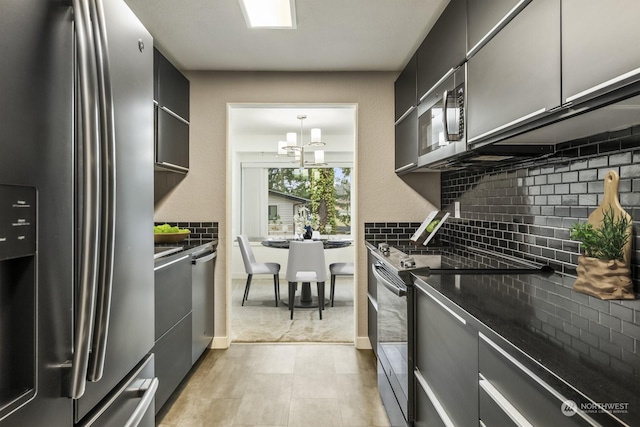 kitchen with tasteful backsplash, decorative light fixtures, stainless steel appliances, and a chandelier