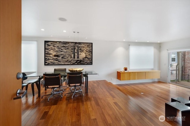 dining room with hardwood / wood-style flooring and a wealth of natural light