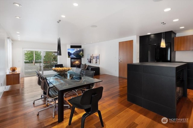 dining space with hardwood / wood-style flooring