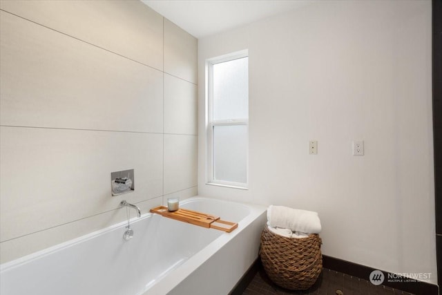 bathroom featuring tile patterned flooring and a tub