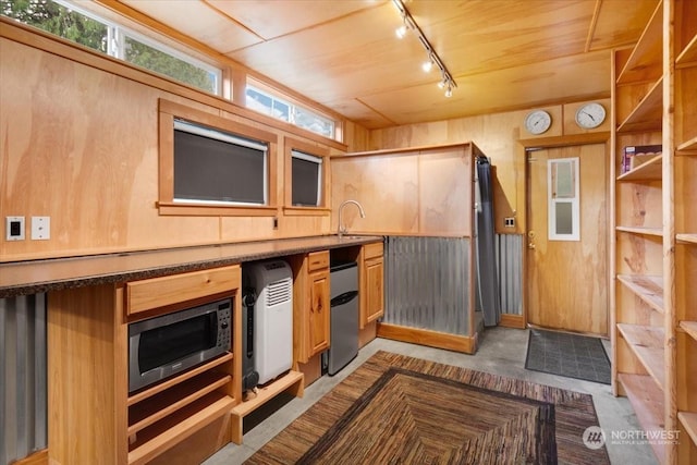 kitchen with refrigerator, built in microwave, sink, wooden ceiling, and wood walls