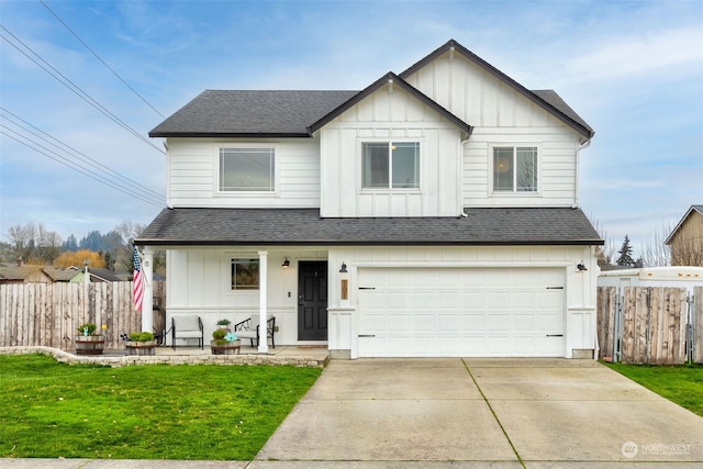 view of front facade featuring covered porch, a garage, and a front yard