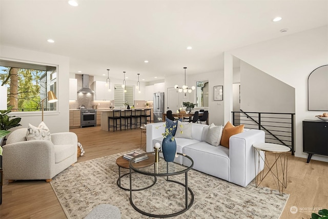 living room with light hardwood / wood-style flooring and a chandelier