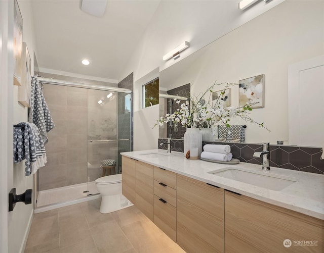 bathroom with tile patterned flooring, vanity, toilet, and an enclosed shower