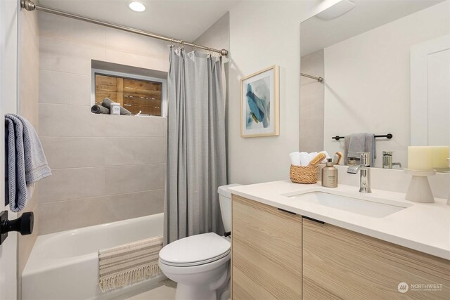 full bathroom with shower / tub combo, vanity, and toilet