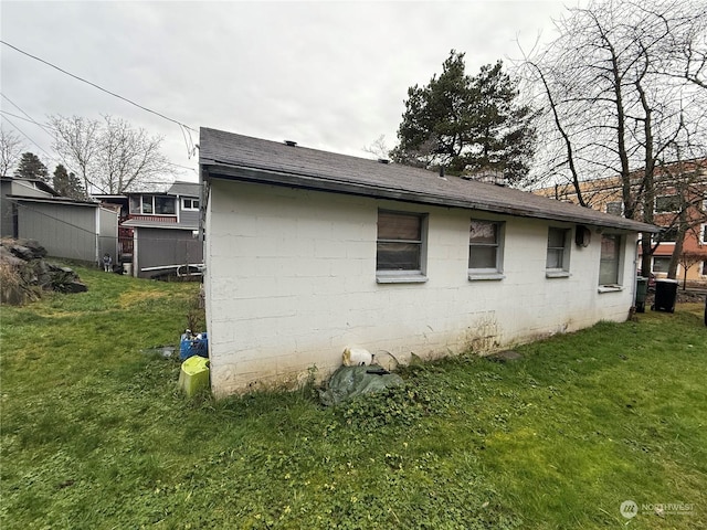 view of side of property with a lawn