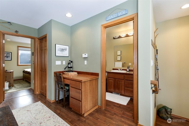 interior space with vanity and hardwood / wood-style flooring