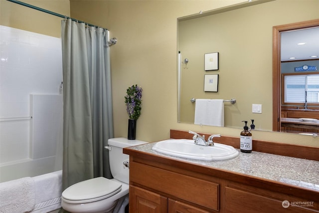 full bathroom with shower / bath combination with curtain, vanity, and toilet