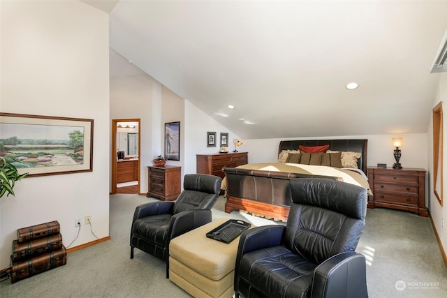 bedroom featuring light colored carpet, ensuite bathroom, and vaulted ceiling