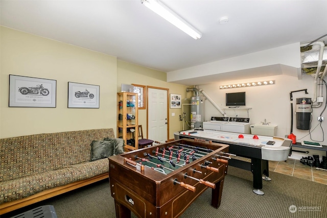 recreation room with washer and dryer and water heater