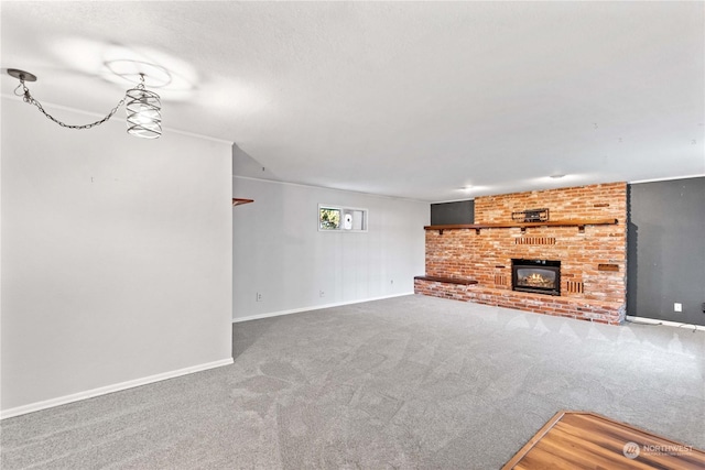 unfurnished living room with a fireplace and carpet