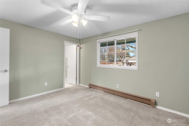 carpeted empty room with ceiling fan, a textured ceiling, and a baseboard heating unit