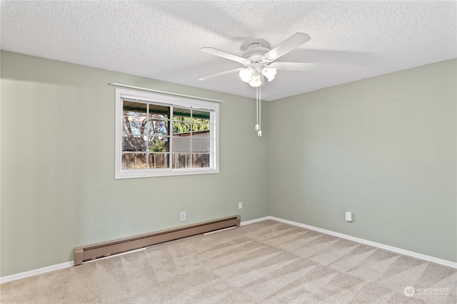 empty room featuring ceiling fan, carpet floors, a baseboard radiator, and a textured ceiling