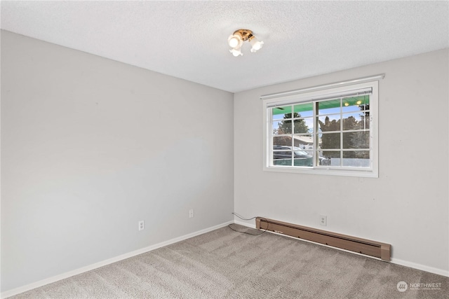 carpeted empty room featuring a textured ceiling and a baseboard heating unit