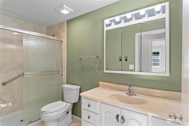 bathroom with vanity, toilet, and an enclosed shower