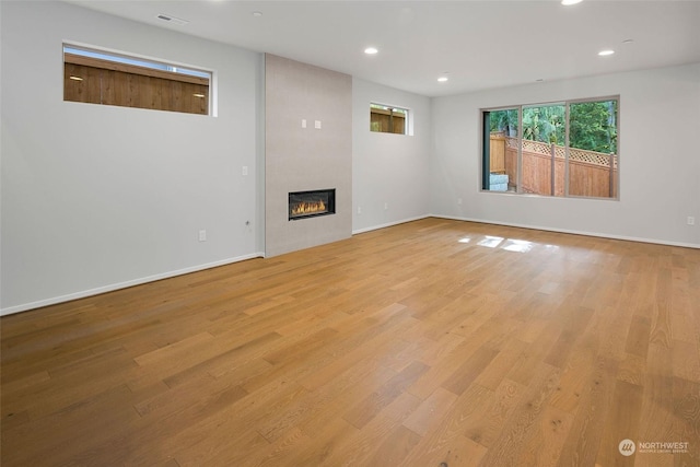 unfurnished living room featuring light hardwood / wood-style floors