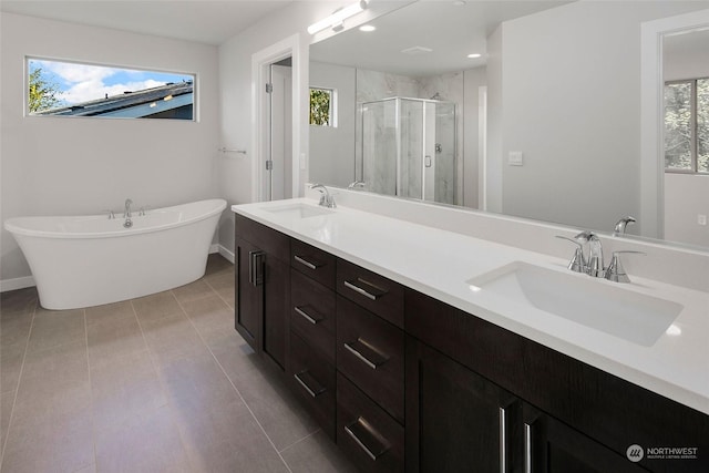 bathroom with plus walk in shower, tile patterned flooring, and vanity