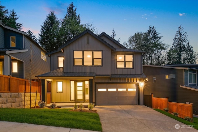 modern farmhouse featuring a lawn, a garage, and covered porch