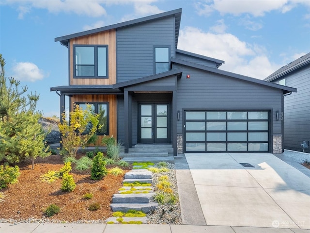 contemporary home with concrete driveway and an attached garage