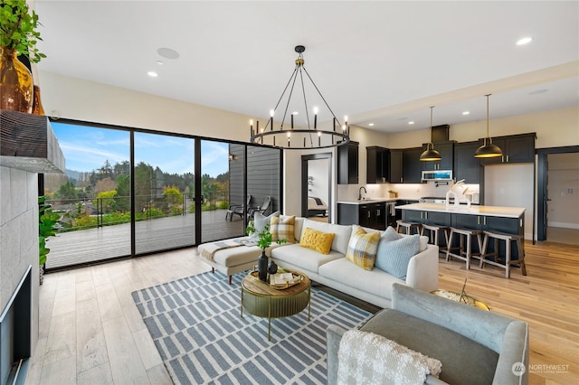 living room featuring an inviting chandelier and light wood-type flooring