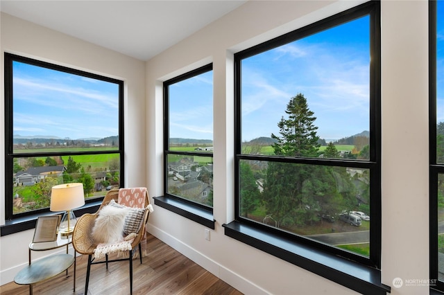 sunroom / solarium featuring a mountain view and a healthy amount of sunlight