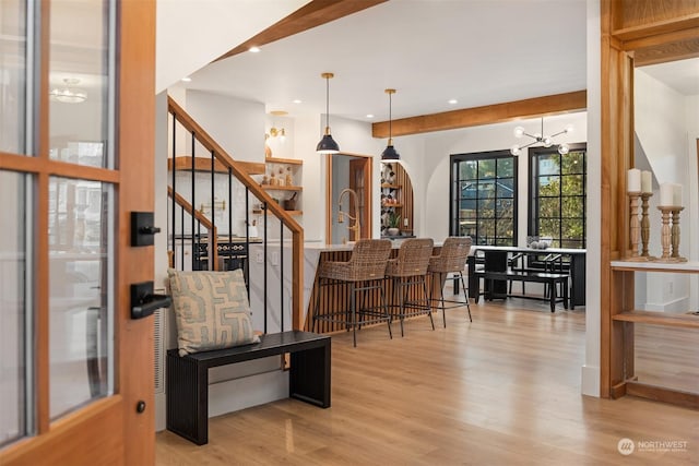 interior space with a chandelier and light hardwood / wood-style flooring