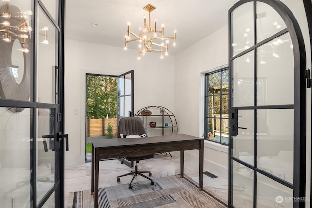 office featuring a notable chandelier and a wealth of natural light