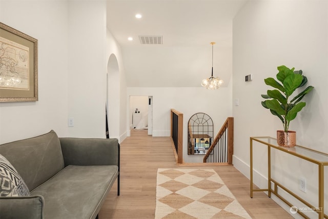 sitting room with a chandelier and light hardwood / wood-style floors