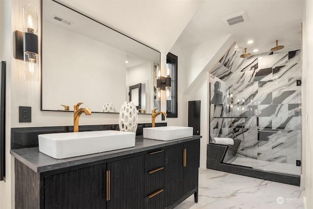 bathroom with a shower with shower door and vanity