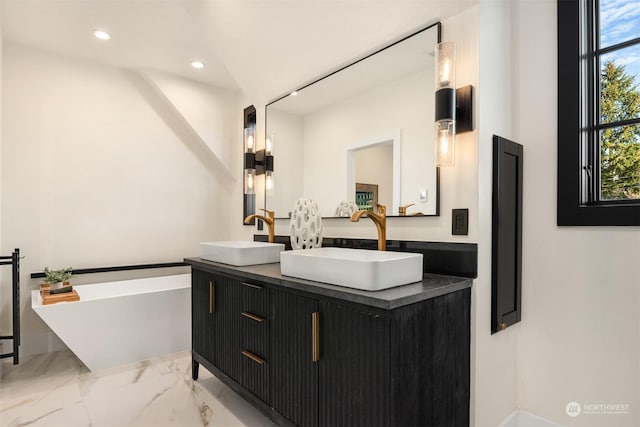 bathroom featuring a tub and vanity