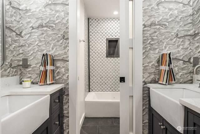 bathroom featuring tile patterned flooring, a tub to relax in, and vanity