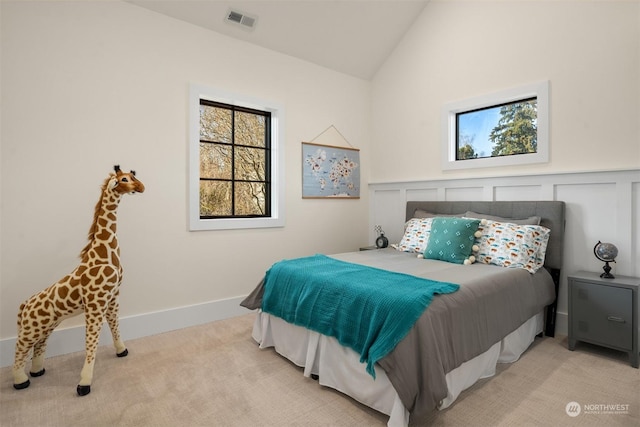 carpeted bedroom featuring lofted ceiling