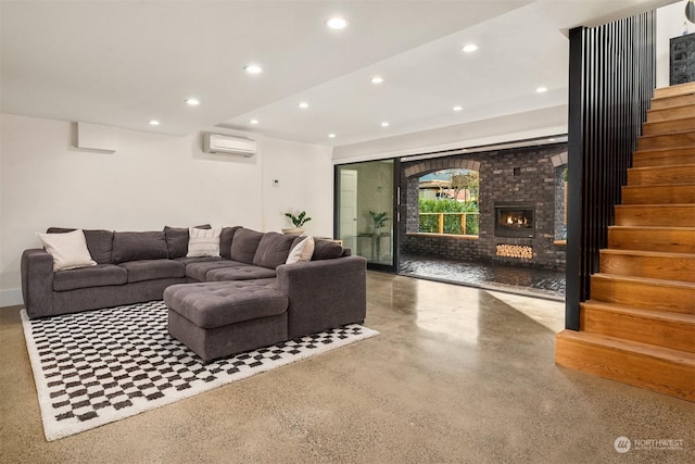 living room with a wall mounted AC and a brick fireplace