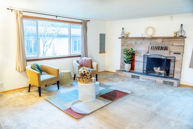 living area featuring carpet, a stone fireplace, and electric panel