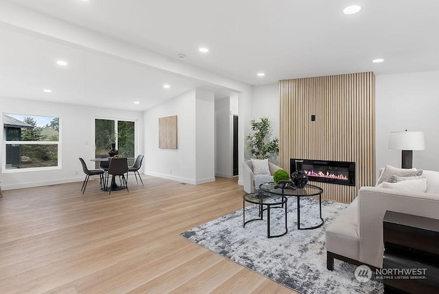 living room with lofted ceiling and light wood-type flooring