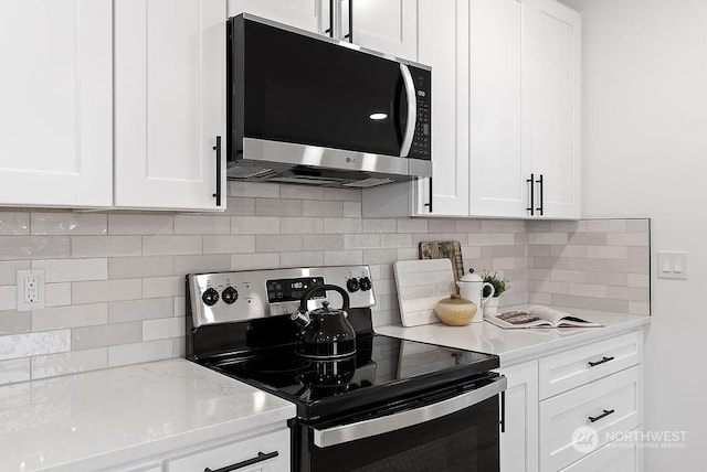 kitchen featuring white cabinetry, backsplash, and appliances with stainless steel finishes